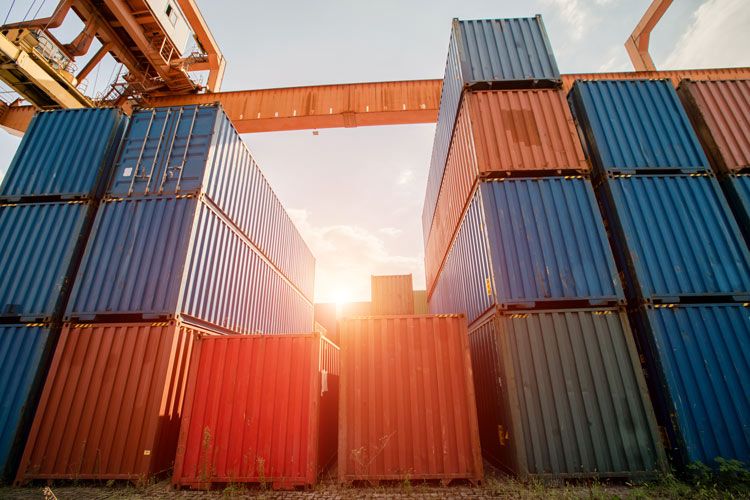 Stacks of shipping containers related to cargo insurance claims.