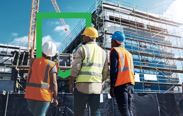 men at a construction site with WS shield in the background