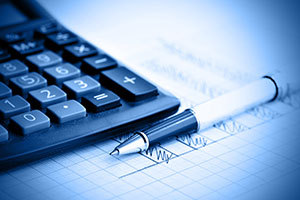 An image of calculator and pen on a piece of paper with pen marking on it.