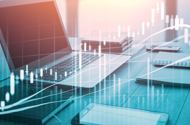 Computer on desk with financial data display