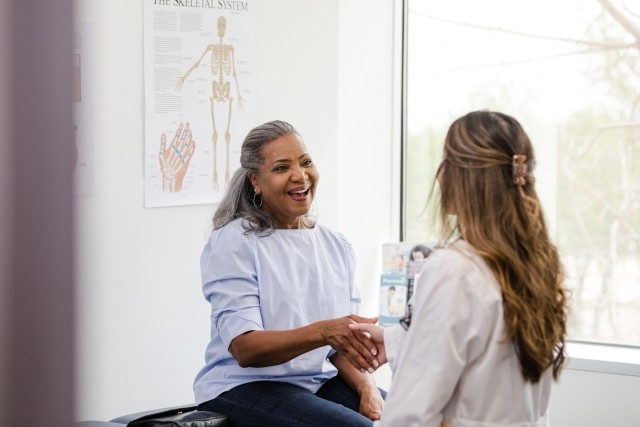 woman and doctor shaking hands