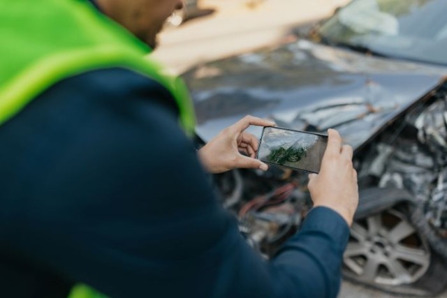 Man taking photo of car crash