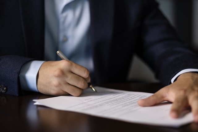 businessman signing paperwork