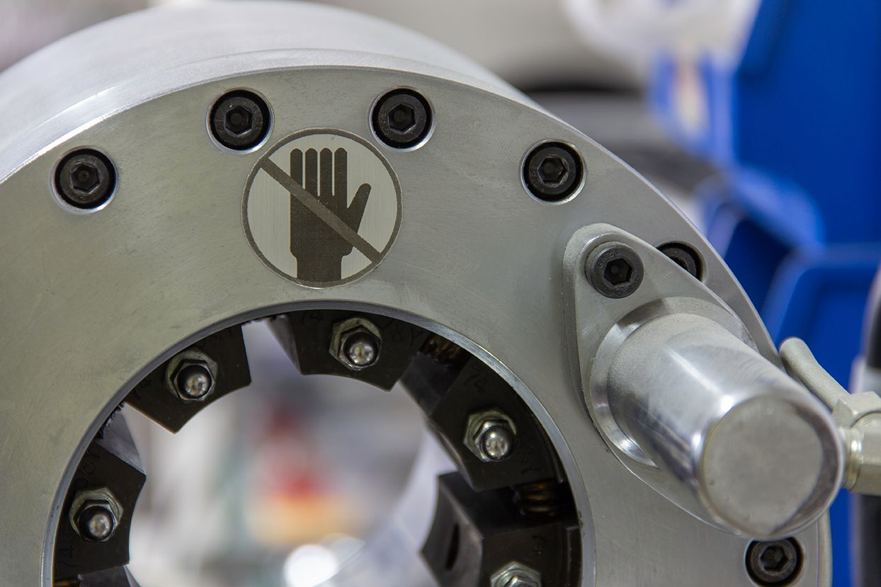 Machinery at manufacturing facility with safety warning sign