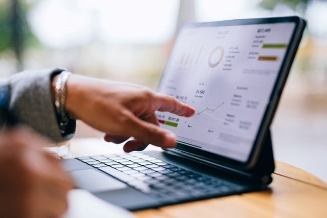 A businessman analyzing financial data on his laptop