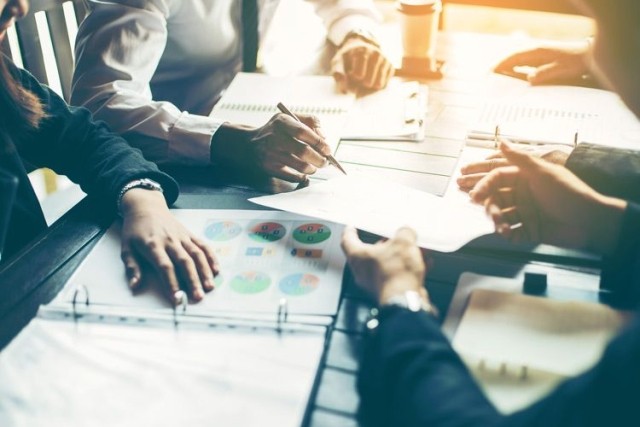 Team discussing insurance rates and analyzing data