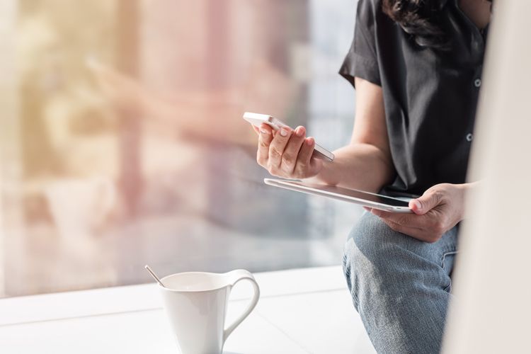 Business woman completing online financial transaction