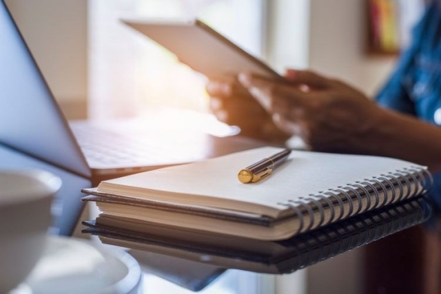woman reviewing tablet notebook