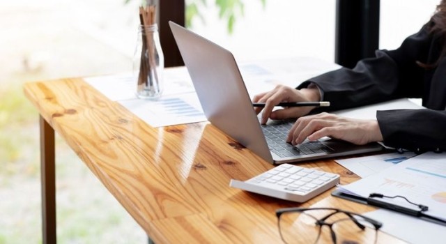 Woman working on computer at her desk.