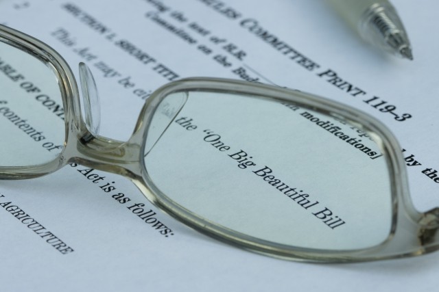 Glasses on top of a copy of the Reconciliation Act