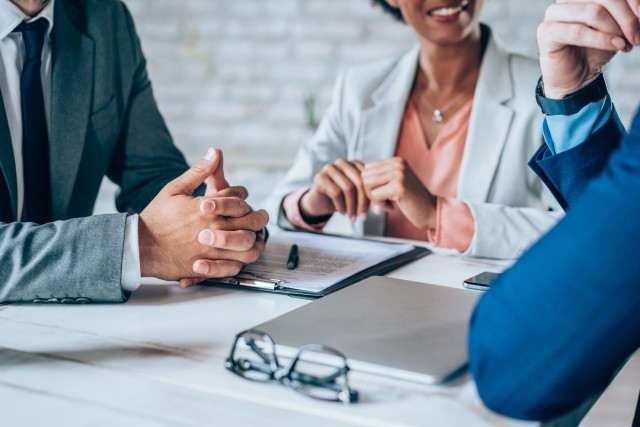 Cropped shot of three business persons in business meeting